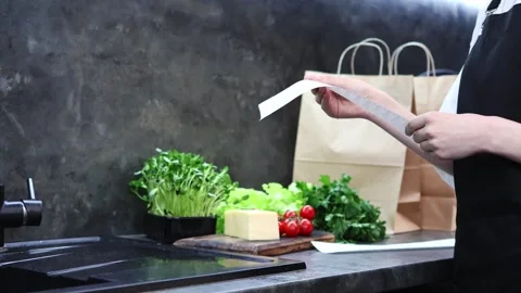 Preparing fresh ingredients in a modern kitchen setting for a delightful meal 스톡 동영상 296315930