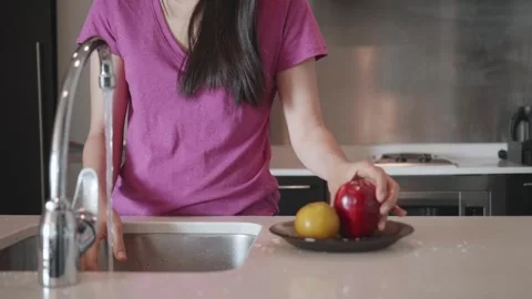 Preparing Fresh Ingredients in a Modern Kitchen Stock Footage 313830319