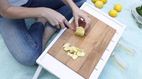Preparing fresh lemon slices for a refreshing drink in a cozy setting Stock Footage 297368516