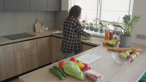 Preparing Fresh Lettuce On Cutting Board In Cozy Kitchen, Cat Peeking Nearby Stock Footage 306395275