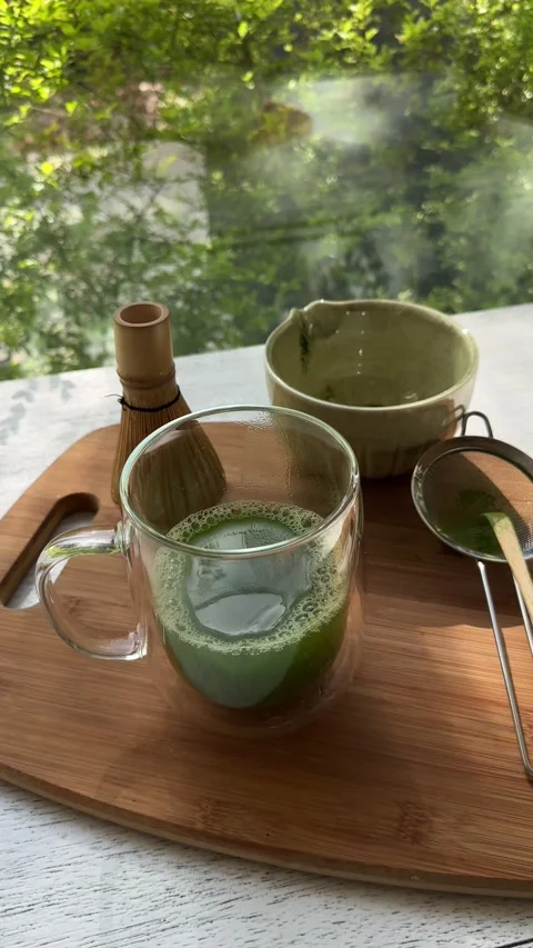 Preparing fresh matcha tea with traditional japanese tools in sunlit kitchen Stock Footage 320851417