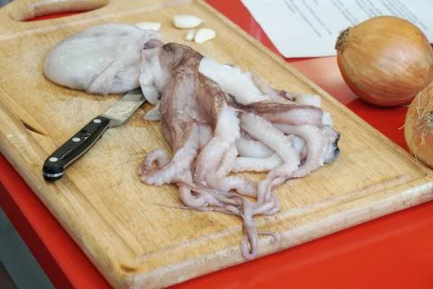 Preparing fresh raw octopus or calamari Stock Photos