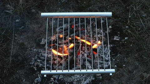 Preparing fresh sausages on the grill in the forest. Top view. Stock Footage 112139723