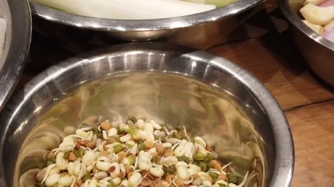 Preparing fresh sprouts and greens for a vibrant culinary dish Stock Footage 330138572