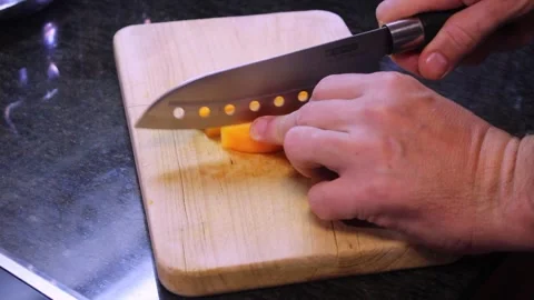 Preparing fresh vegetables for a healthy meal on a wooden cutting board Stock Footage 294582917