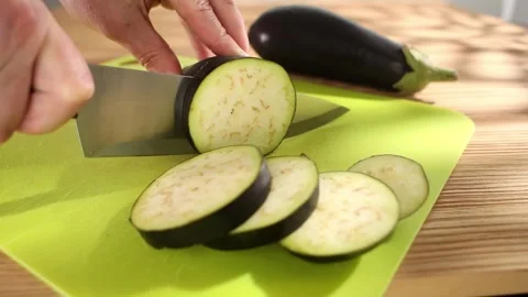 Preparing fresh vegetables. slicing eggplant on a cutting board. healthly food. Stock Footage 244444433