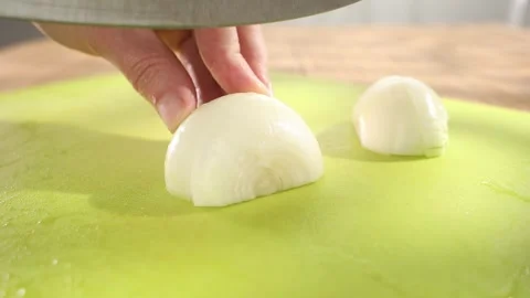Preparing fresh vegetables. slicing onions on a cutting board. healthly food. Stock Footage 244444151