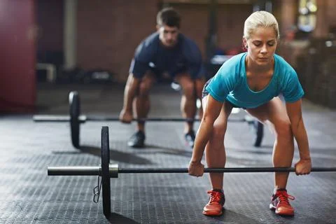 Preparing for the frst pull. two people lifting weights in a gym. Stock Photos