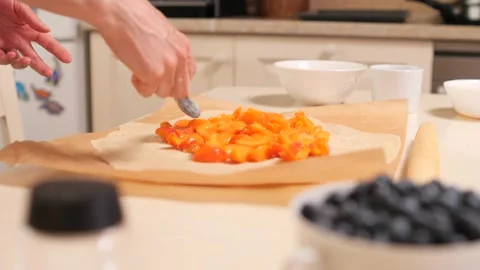 Preparing a fruit galette in a home kitchen, step-by-step process Stock Footage 282371560