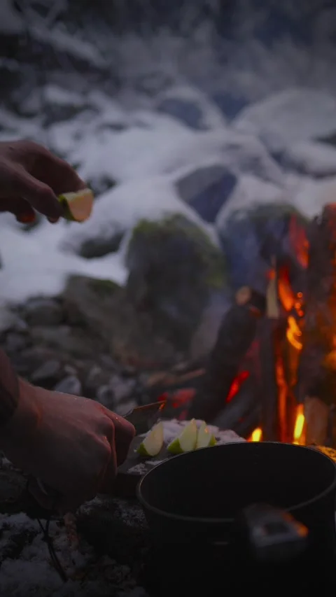 Preparing Fruits for Mulled Wine by Campfire in Forest – Vertical Video Stock Footage 310219101