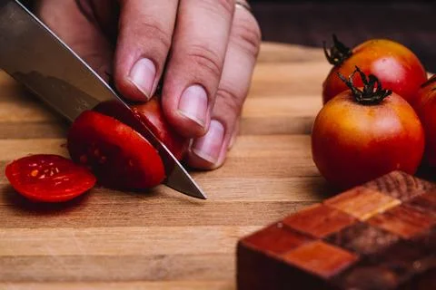 Preparing garden tomatoes to make a salad. Stock Photos