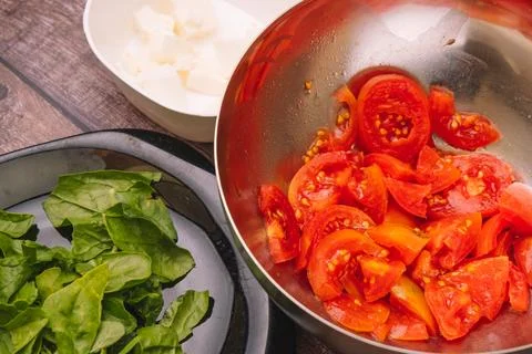 Preparing garden tomatoes to make a salad. Stock Photos