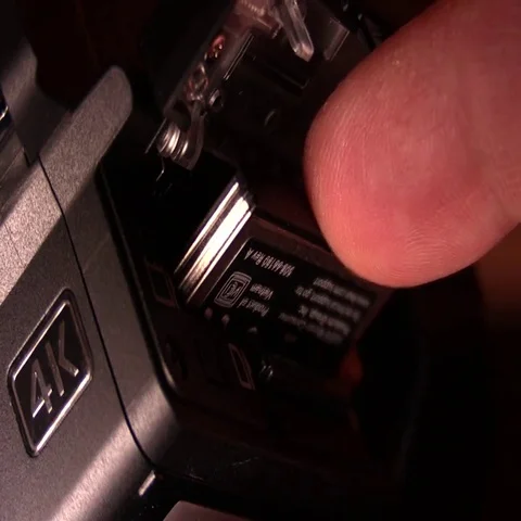 Preparing Gear - Inserting Memory Card in 4K Camera Video stock 69700046