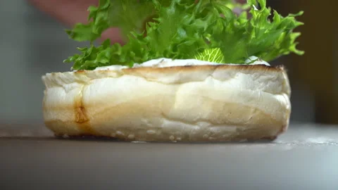 Preparing gourmet burger, adding greens, close up Stock Footage 205304174