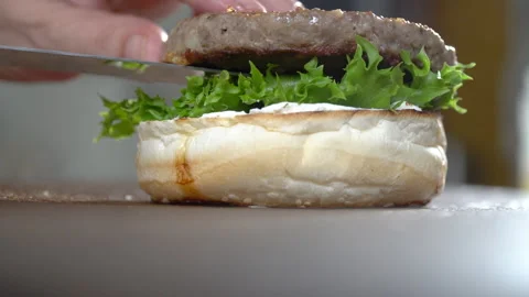 Preparing gourmet burger, adding meat patty, close up Stock Footage 205302584