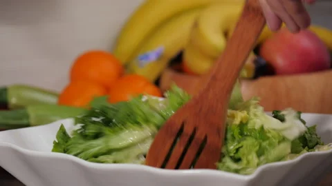 Preparing a gourmet salad with lettuce Stock Footage 154338009