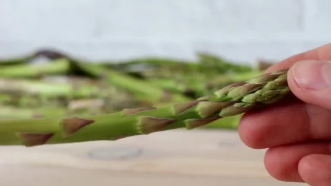 Preparing green asparagus to eat bake cook Stock Footage 75746524
