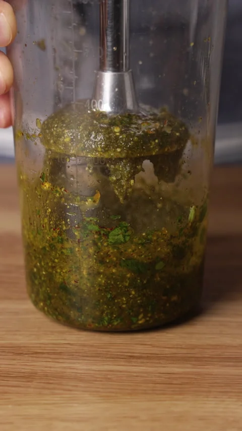 Preparing Green Herb Sauce with Immersion Blender Close Up Видео 329889050