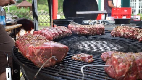 Preparing to grill roast beef on barbecue Stock Footage 92234519