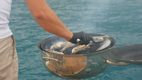 Preparing grilled fish outdoors Stock Footage 126909622