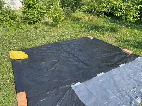 Preparing ground base for inflatable pool 写真素材