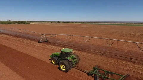 Preparing the Harvest: Aerial View of Tractor Working in Crop Field Stock Footage 243572654