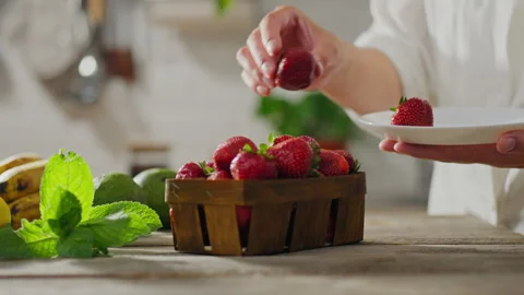 Preparing healthy breakfast in sunny kitchen. Kitchen table adorned fruits o Stock Footage 246537466