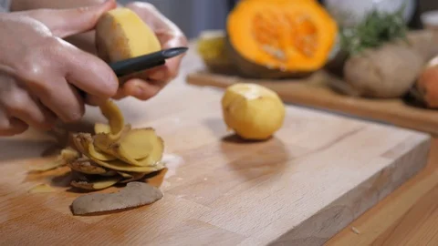 Preparing healthy eating vegetable organic food, peeling potatoes Stock Footage 104554855