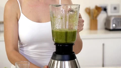 Preparing a Healthy Green Smoothie in the Kitchen Stock Footage 314303564