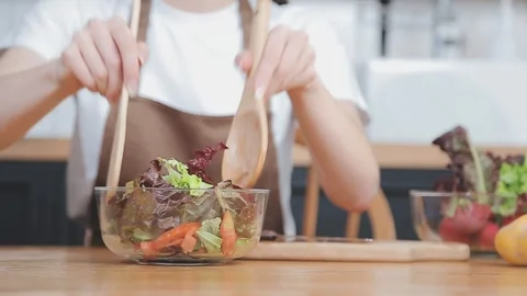 Preparing healthy salad with fresh vegetables and herbs in kitchen Stock Footage 325446287