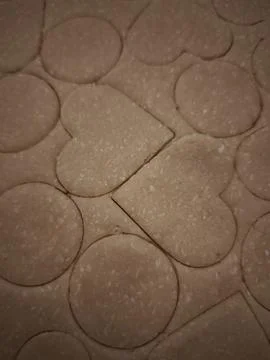 Preparing heart and circle shaped cookies from dough for valentine's day Stock Photos