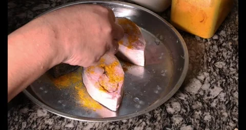 Preparing hilsa fish cut pieces for Asian Bengali cooking frying rubbing me.. Stock Footage 275003578
