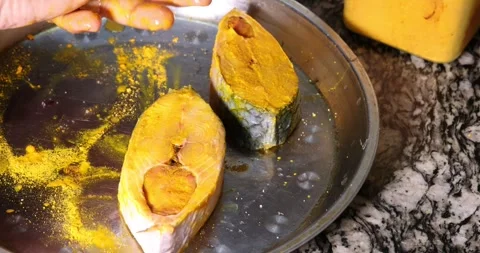 Preparing hilsa fish cut pieces for Asian Bengali cooking frying rubbing me.. Stock Footage 275003594