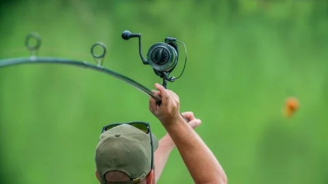 Preparing himself to throw a fishing rod into the water  Stock Footage 112176306