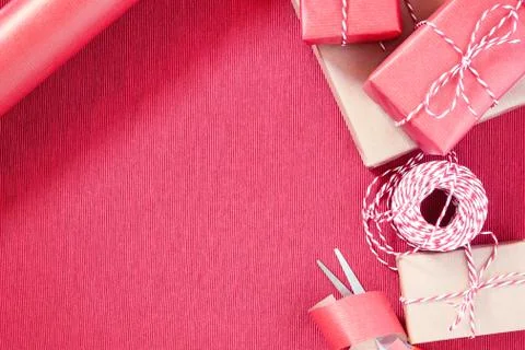 Preparing for the holiday - gift wrapping in red and beige wrapping paper Stock Photos