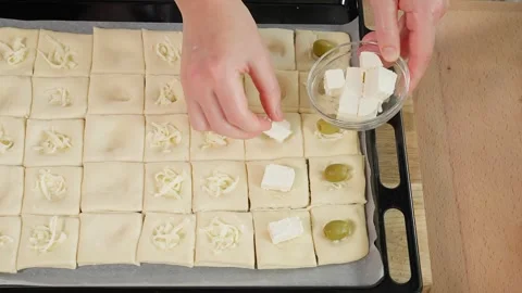 Preparing a holiday snack. Puff pastry squares Stock Footage 255408491
