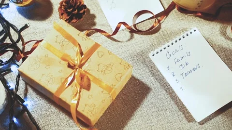 Preparing for the holidays. List of goals and planning gifts for the new year. Stock Footage 100637517