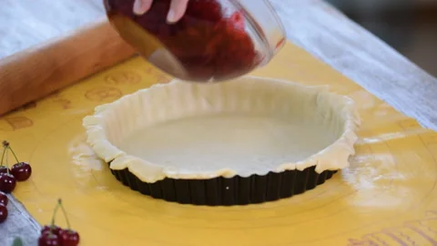 Preparing at home fresh and sweet homemade cherry pie on a kitchen counter Stock Footage 116766616