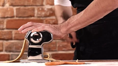 Preparing home made pasta with pasta maker. Chef use pasta cutting machine. Stock-Footage 150779916