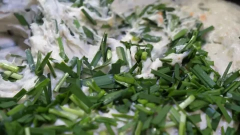 Preparing Homemade Korean Fish Cake Mix with Fresh Chopped Chives Stock Footage 337374612