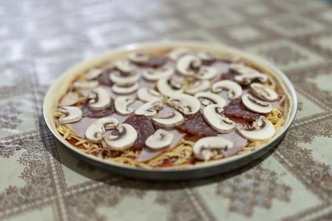 Preparing homemade pizza on kitchen table 写真素材