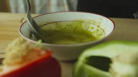 Preparing homemade salad dressing in the kitchen, close-up detail. Mixing fresh Stock Footage 340384992
