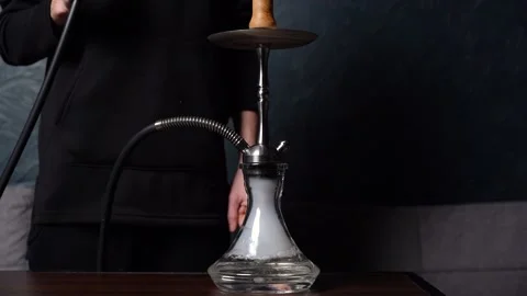 Preparing hookah. Step by step. Hookah man lights hookah and blows smoke. Stock Footage 153217343