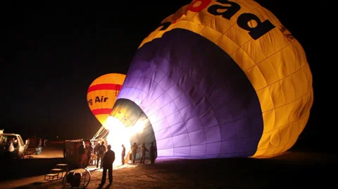 Preparing hot-air balloons for flight at night in Luxor, Egypt Stock Footage 38723929