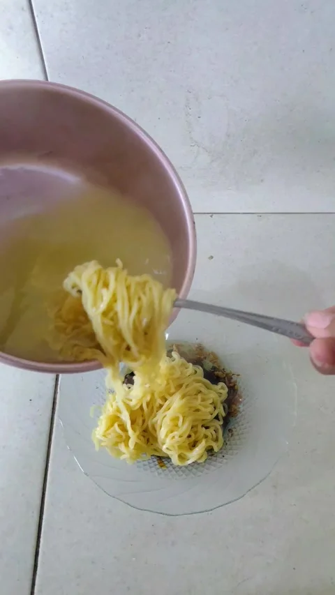 Preparing Instant Noodles: Drain &amp; Serve Stock Footage 312183837