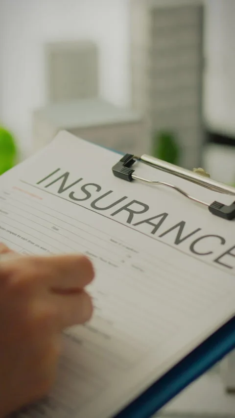 Preparing insurance documentation for real estate investment in a modern off Stock Footage 331721826