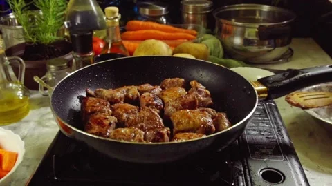 Preparing Irish stew: beef, potatoes, carrots and herbs. Slow motion Stock Footage 98237448