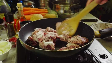Preparing Irish stew: beef, potatoes, carrots and herbs Stock Footage 98238169