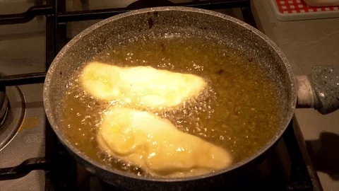 Preparing italian stuffed panzerotti fried in the pan Stock Footage 83781772