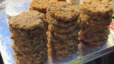 Preparing large quantities delicious street fast food. Crispy pancakes absorb Stock Footage 322564870
